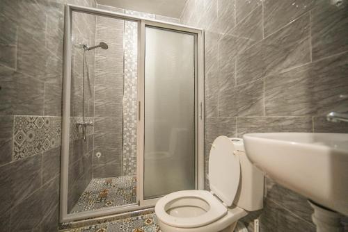 a bathroom with a shower and a toilet and a sink at Surf Break Morocco in Imsouane