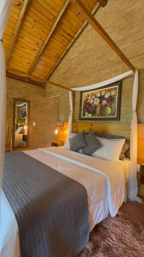 a bedroom with two beds in a room at Chalés Villa Caravaggio in Santa Teresa