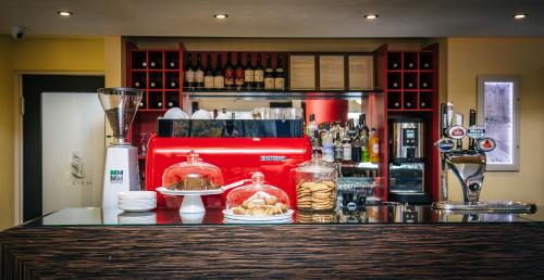 a bar with a counter with food and a bartender at The Lincoln Hotel in Lincoln