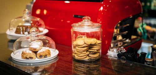 a table with plates of pastries and a jar of cookies at The Lincoln Hotel in Lincoln