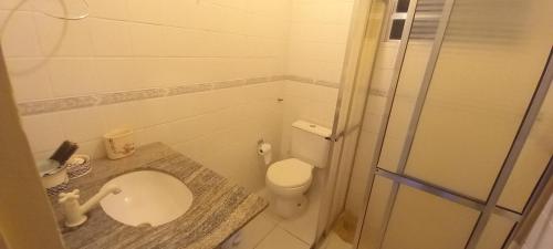 a bathroom with a toilet and a sink and a shower at Casa Aconchegante in São Sebastião