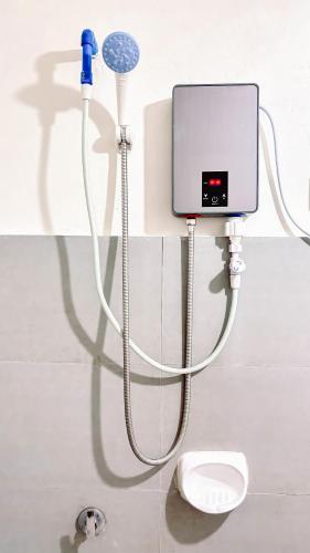 a bathroom with a shower and a toilet in a room at Huddle Pad in Baguio