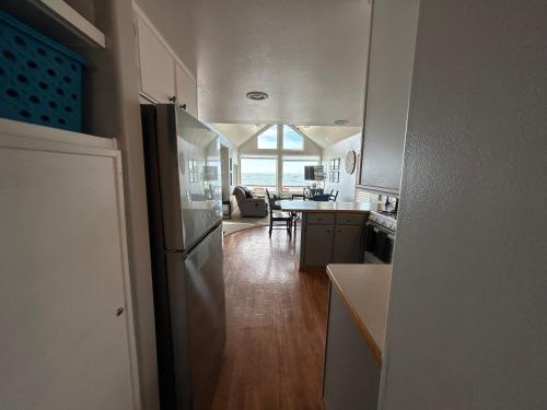 a kitchen with a refrigerator and a living room at Oceanfront Cabin 6 W Jacuzzi &awe-inspiring View in Smith River