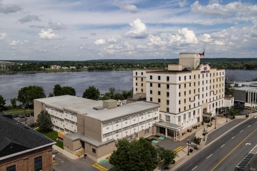 an aerial view of a building next to a river at Crowne Plaza Fredericton Lord Beaverbrook by IHG in Fredericton