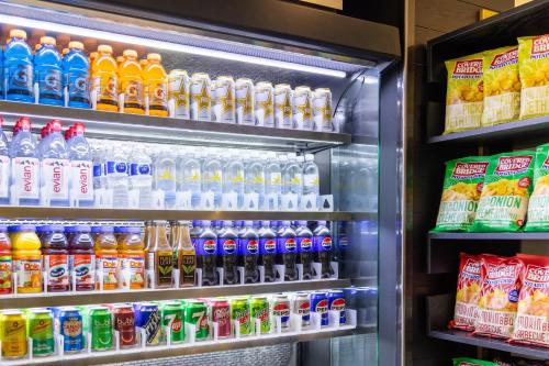 a refrigerator filled with lots of different types of drinks at Crowne Plaza Fredericton Lord Beaverbrook by IHG in Fredericton