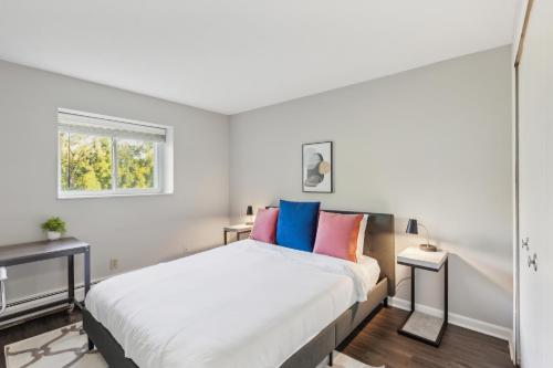a bedroom with a large white bed with colorful pillows at Scenic Towers 3020 I Cozy & Comfy I Free Parking in Parma