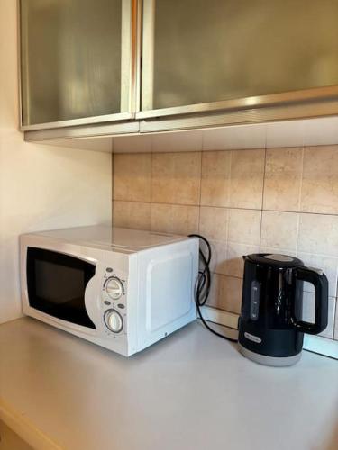 a microwave sitting on top of a kitchen counter at Borgo Del Colle in Colle Umberto