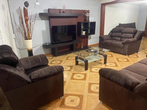 a living room with two couches and a fireplace at Residencia en Chignahuapan in Chignahuapan