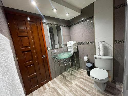 a bathroom with a toilet and a sink at Residencia en Chignahuapan in Chignahuapan