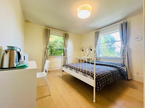 a small bedroom with a bed and a window at Meet友缘 in Vancouver