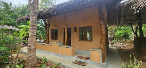 a building with stairs on the side of it at Undiya The Neighborhood Sigiriya in Sigiriya