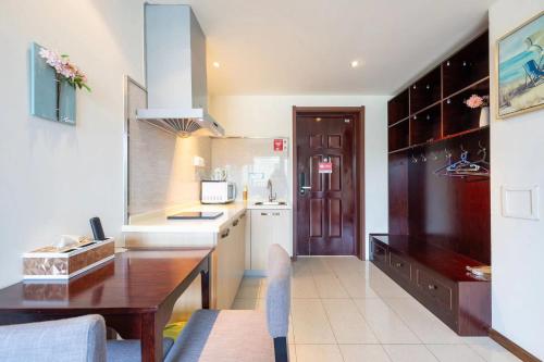 a kitchen with a wooden table and a counter top at Gubei Water Town Landscape Villa in Miyun