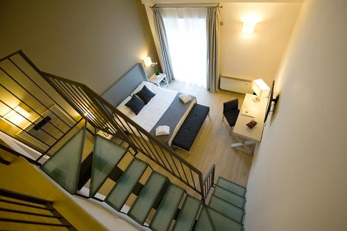 a view of a bedroom with a bed and a staircase at Relais dell'Olmo in Perugia