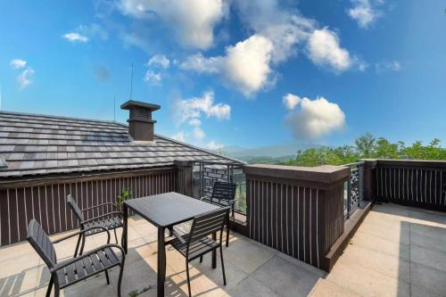 a patio with a table and chairs on a deck at Gubei Water Town Landscape Villa in Miyun