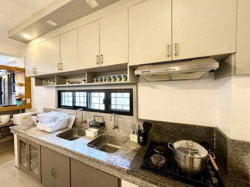 a kitchen with a sink and a counter top at Homey & spacious with private plunge pool ktv near SMtela in Santo Domingo