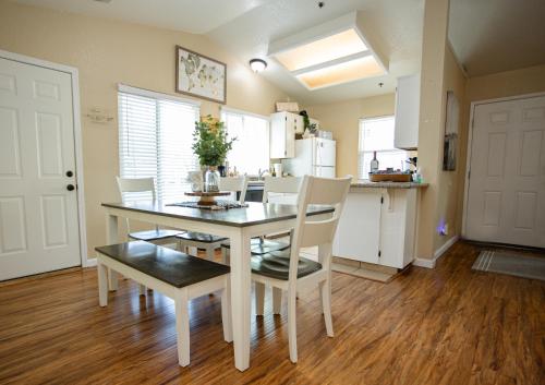a kitchen and dining room with a table and chairs at Cozy Condo minutes from the Sequoia National Park in Three Rivers