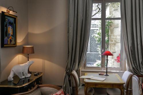 a living room with a desk and a window at La Cour Berbisey - Teritoria in Dijon