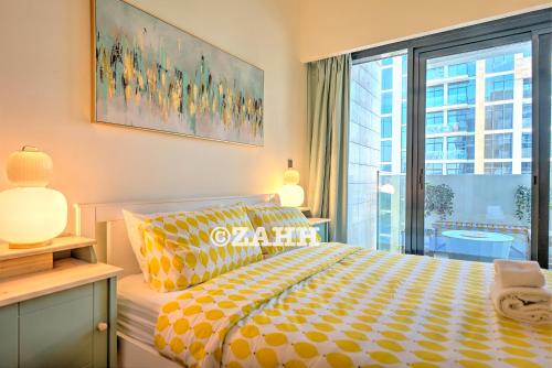 a bedroom with a bed and a large window at Cozy Crib in Dubai