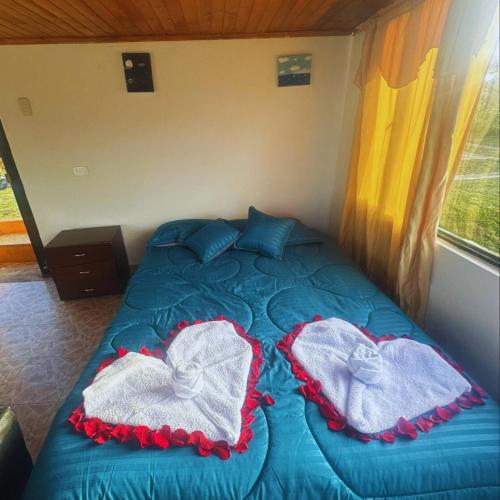 a bed with towels on it in a room at Glamping Terranova Guatavita Colombia in Guasca