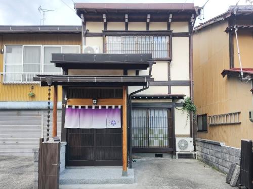 an entrance to a building with a gate at すみれ庵FUKIYAvillas in Takayama