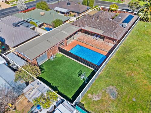 an overhead view of a house with a swimming pool at Retreat House in Yarrawonga