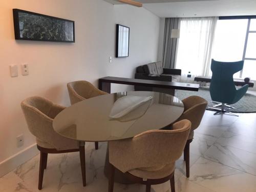 a living room with a table and chairs at Hotel Nacional Rio de Janeiro in Rio de Janeiro