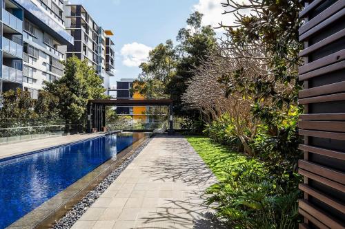 an external view of a swimming pool in a building at Balinese Charm meets Resort Living in Inner Sydney in Sydney