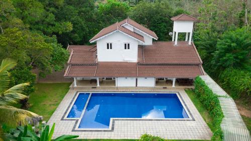 an aerial view of a house with a swimming pool at Tara Garden Sri Lanka - luxury colonial villa in Danwattegoda