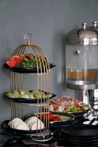 a plate of food on a table with plates of food at The Gate Boutique Hotel Đà Lạt in Da Lat