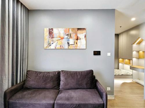 a living room with a couch and a painting on the wall at Homestay Ocean park Gia Lâm in Hanoi