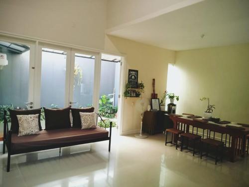 a living room with a couch and a dining table at The Icon Homestay Malang in Blimbing