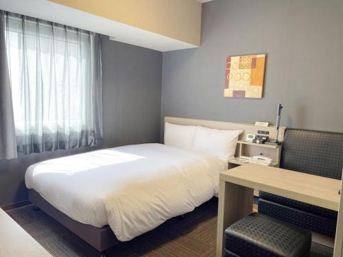Кровать или кровати в номере Hotel Route-Inn Tokyo Kamata -Ayamebashi-