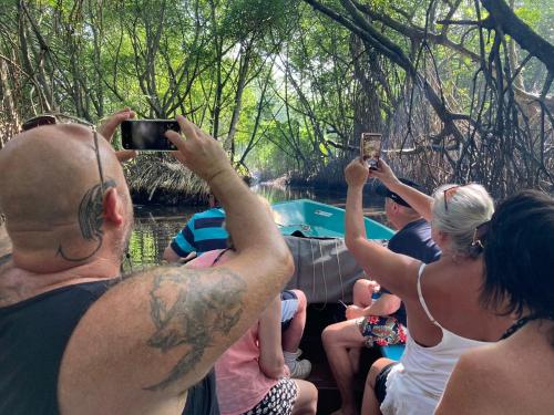 a group of people taking pictures of a boat at Tara Garden Sri Lanka - luxury colonial villa in Danwattegoda