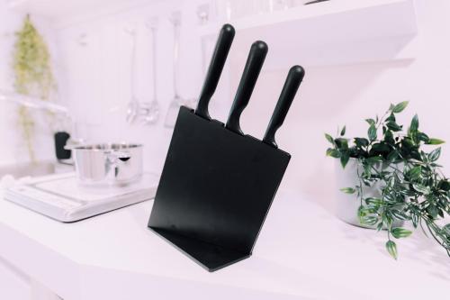 two black holders sitting on a counter with plants at Minimalist Loft Namba Compact Studio with a 24-hour Gym MA502 in Osaka