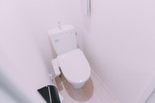 a bathroom with a white toilet in a room at Minimalist Loft Namba Compact Studio with a 24-hour Gym MA502 in Osaka
