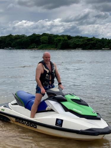 a man standing on a jet ski in the water at Tara Garden Sri Lanka - luxury colonial villa in Danwattegoda