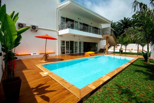 a villa with a swimming pool in front of a house at 8 Palm Villa - Private Pool Villas in Aonang in Ao Nang Beach