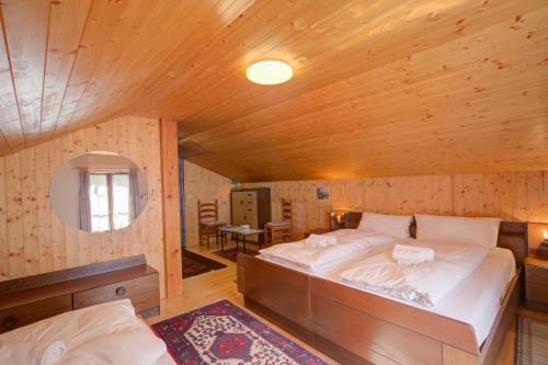 a bedroom with a large bed in a wooden room at Ca Contina - Happy Rentals in Frasco