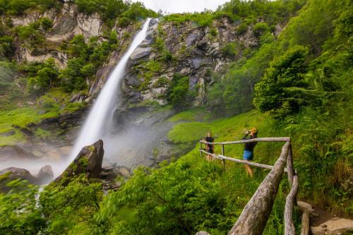 a group of people standing in front of a waterfall at Ca Contina - Happy Rentals in Frasco