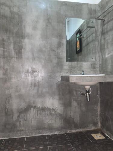 a bathroom with a sink and a mirror at Sakun House in Siem Reap