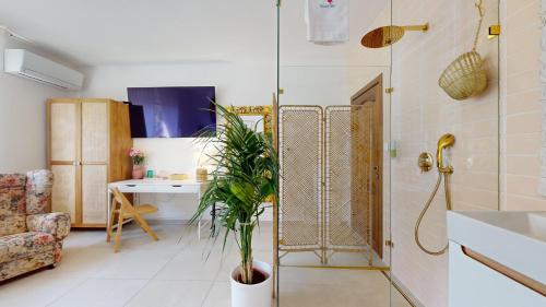 a bathroom with a shower and a plant in it at Ron De Mar - FLAMINGO in Pezinok