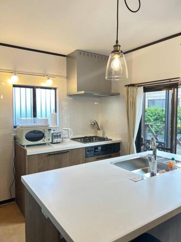 a kitchen with a sink and a counter top at Kukuna外房 in Mobara