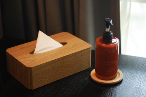 a wooden box with a bottle of fire extinguisher next to a wooden box at Hotel Clover Asoke - SHA Extra Plus in Bangkok