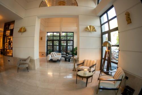 a living room filled with furniture and a large window at Cosmopolita Boutique Hotel in Timişoara