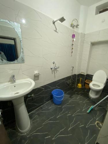 a bathroom with a sink and a toilet and a mirror at Blue Eye Hostel in Jaisalmer
