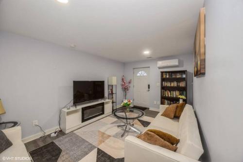 a living room with a couch and a tv at Charming Unit in Yonkers Close to NYC in Yonkers