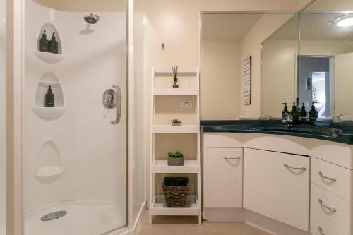 a bathroom with a shower and a sink at Acacia Waters - Lake Taupo in Taupo