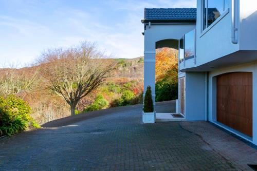 a driveway of a house with a garage at Acacia Waters - Lake Taupo in Taupo