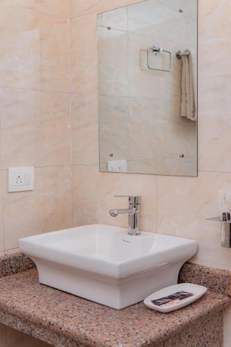 a bathroom with a white sink and a mirror at Hotel Murano in Pokhara