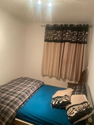 a small bedroom with a bed and a window at Jakes hideout at James cook in Middlesbrough